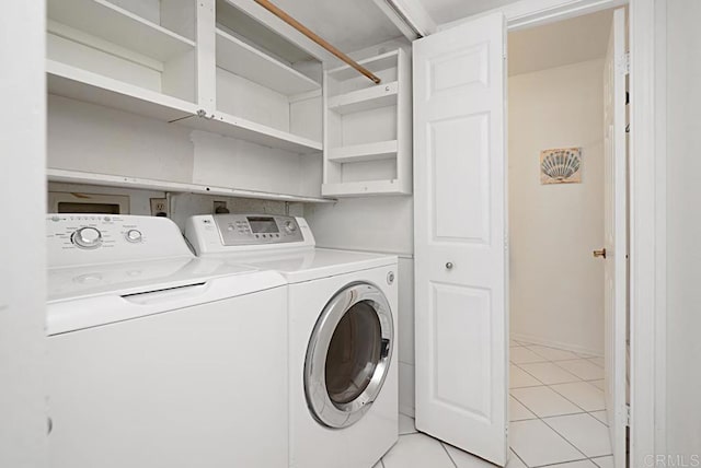 laundry room featuring washer and dryer and light tile patterned flooring