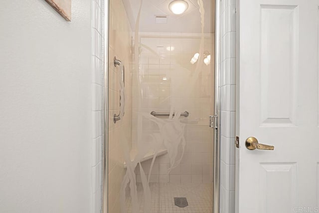 bathroom featuring a shower with door