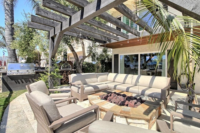 view of patio / terrace featuring exterior kitchen, an outdoor living space with a fire pit, grilling area, and a pergola