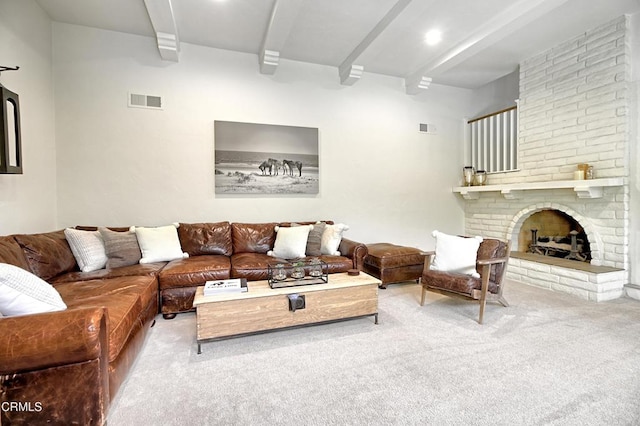 carpeted living room with beamed ceiling and a fireplace