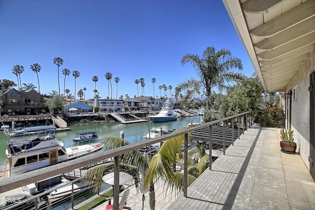 balcony with a boat dock and a water view