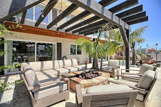 view of patio / terrace featuring an outdoor living space with a fire pit and a pergola