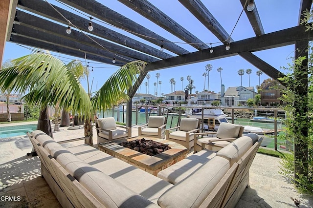 view of patio featuring a dock, a fire pit, and a residential view
