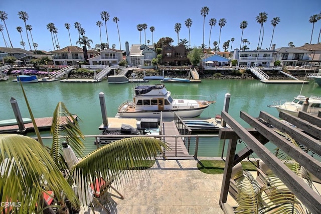 dock area with a residential view and a water view