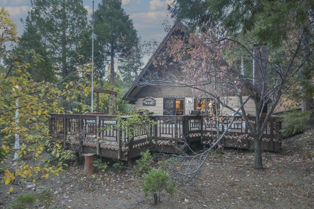 rear view of house featuring a deck