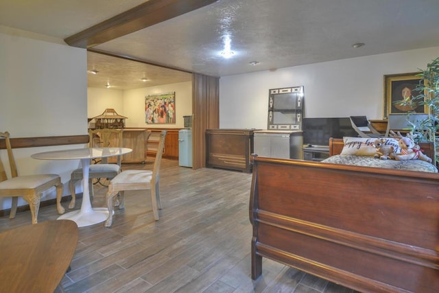 interior space featuring beam ceiling and hardwood / wood-style floors