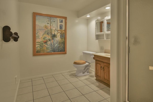 bathroom featuring walk in shower, vanity, toilet, and tile patterned flooring