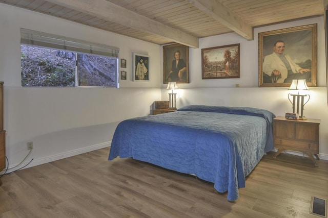 bedroom with beam ceiling, wood ceiling, and wood-type flooring