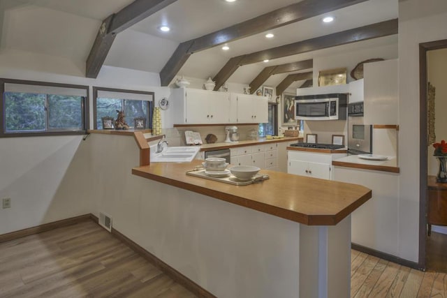 kitchen featuring stainless steel appliances, sink, white cabinets, and kitchen peninsula