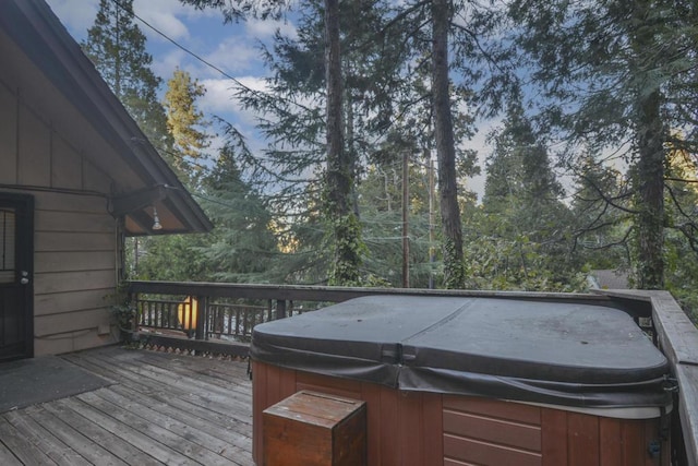 wooden deck with a hot tub