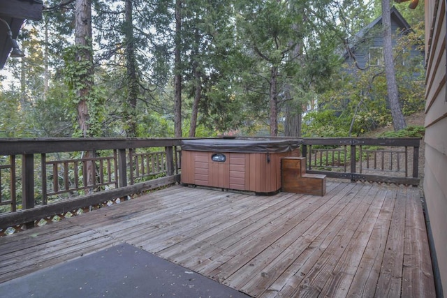 wooden deck with a hot tub