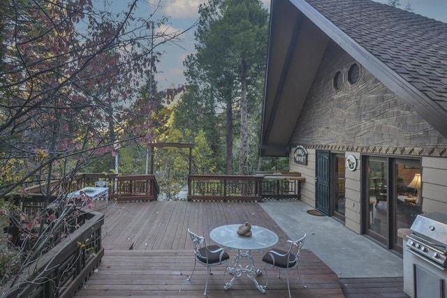 deck at dusk featuring grilling area