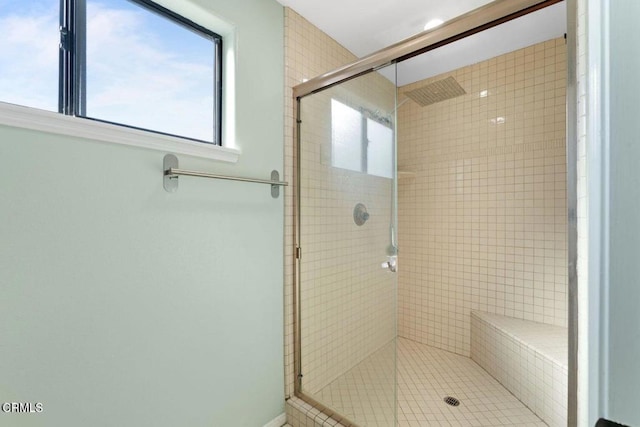 bathroom with a shower with door