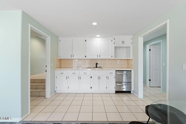 kitchen with white cabinetry, sink, and light tile patterned floors