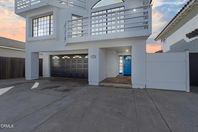 view of garage at dusk