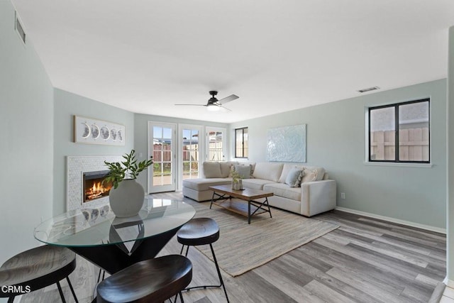 living room featuring ceiling fan and light hardwood / wood-style floors