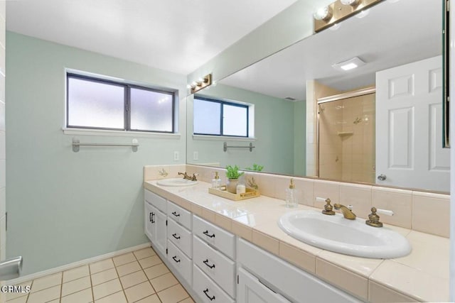 bathroom featuring walk in shower, vanity, and tile patterned flooring