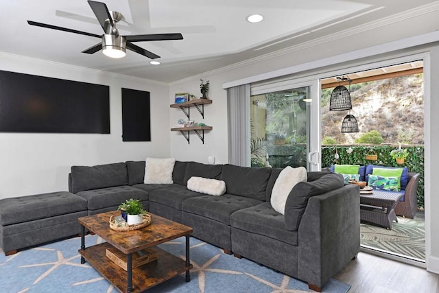 living room with crown molding, ceiling fan, and light wood-type flooring