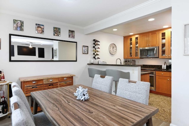 dining area with ornamental molding and sink