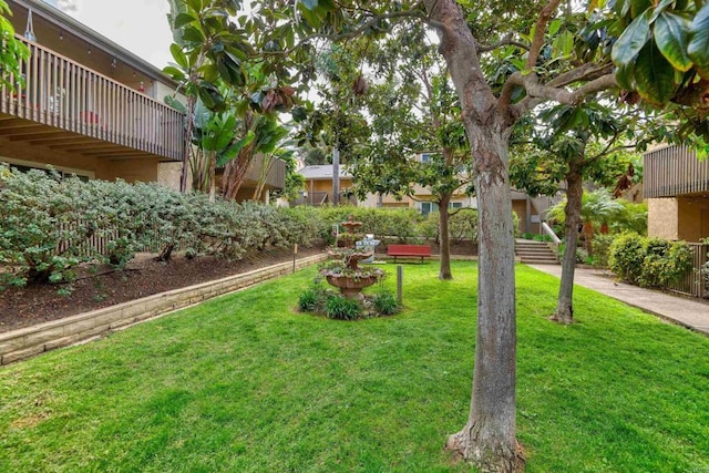 view of yard with a balcony