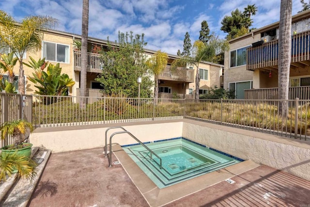 view of swimming pool with a community hot tub and a patio area