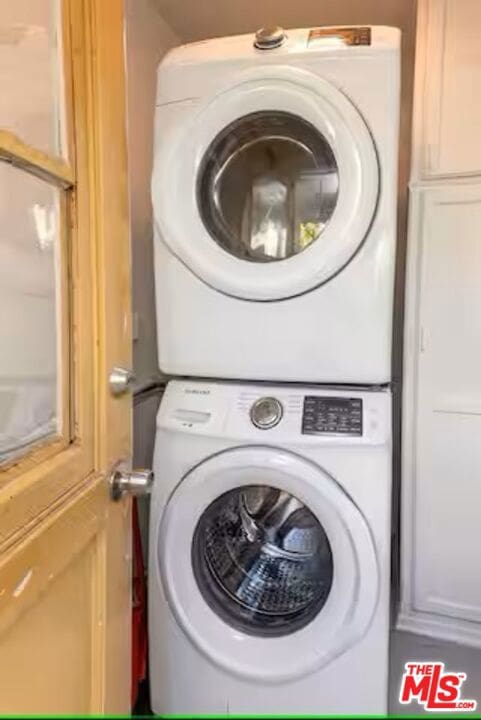 laundry room featuring stacked washer / dryer