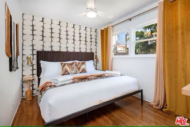 bedroom featuring dark wood-type flooring and ceiling fan