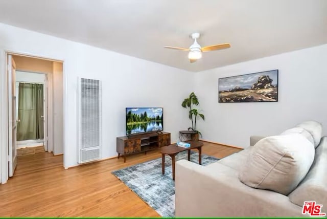 living room featuring ceiling fan and light hardwood / wood-style flooring