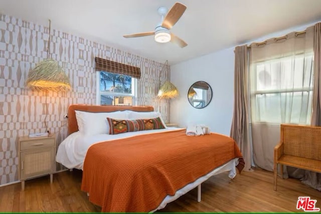 bedroom with wood-type flooring and ceiling fan