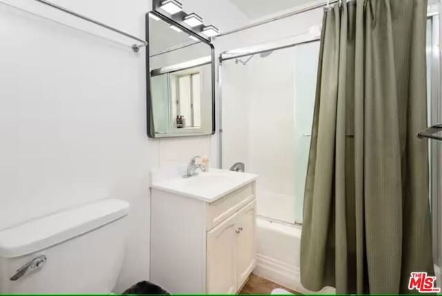 full bathroom with vanity, shower / bathtub combination with curtain, and toilet