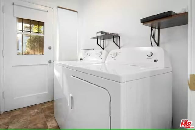 clothes washing area featuring washer and dryer