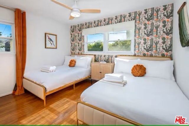 bedroom with ceiling fan and light wood-type flooring