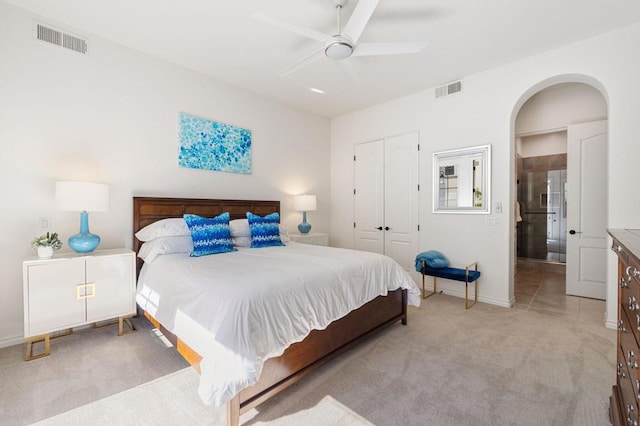 bedroom featuring light carpet, ceiling fan, and a closet