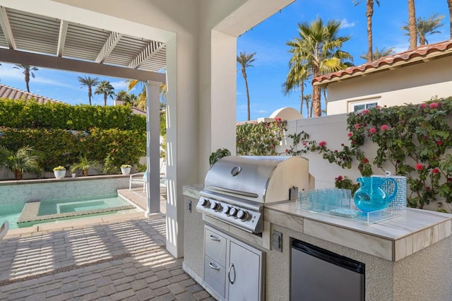 view of patio / terrace featuring grilling area and an outdoor kitchen