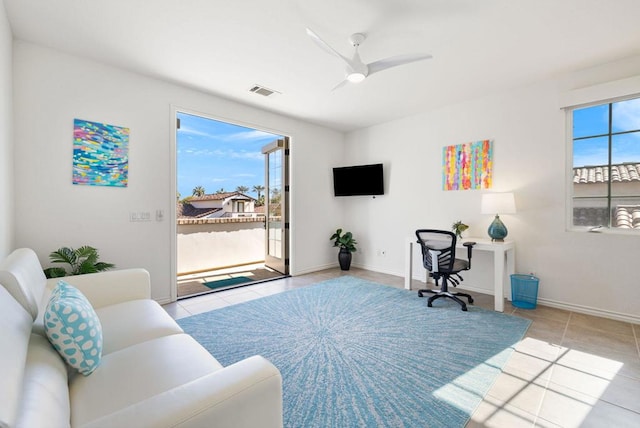 office area with ceiling fan and light tile patterned floors