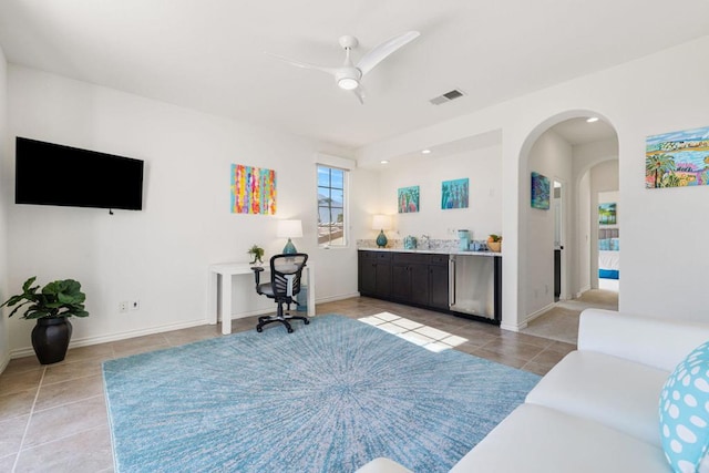 tiled living room featuring ceiling fan