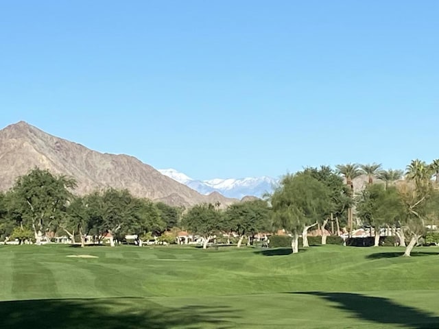 view of community with a mountain view and a yard