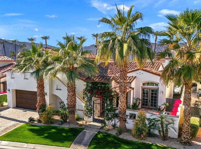 mediterranean / spanish home featuring a garage