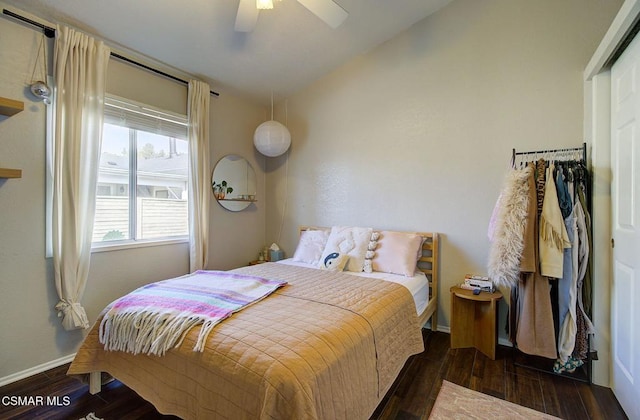 bedroom with dark wood-type flooring, ceiling fan, and lofted ceiling