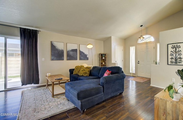 living room featuring dark hardwood / wood-style floors and vaulted ceiling