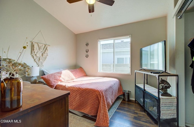 bedroom with dark wood-type flooring, ceiling fan, and vaulted ceiling