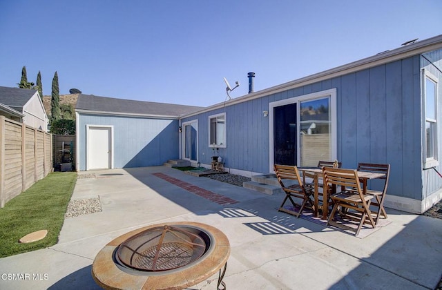 back of house with an outdoor fire pit and a patio area