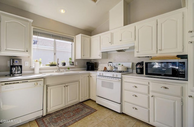 kitchen featuring lofted ceiling, sink, white cabinets, and white appliances