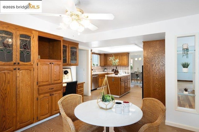 dining area with ceiling fan and light hardwood / wood-style flooring