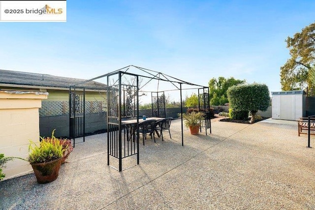 view of patio / terrace with a shed