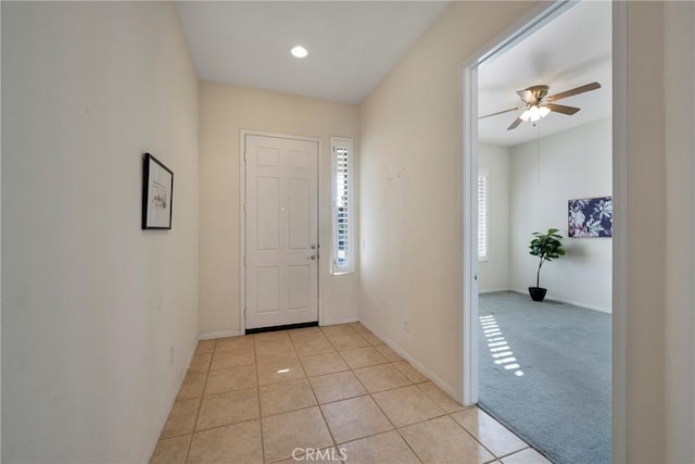 tiled entryway with ceiling fan