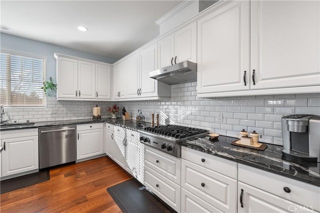 kitchen with white cabinetry, sink, dark stone counters, and appliances with stainless steel finishes