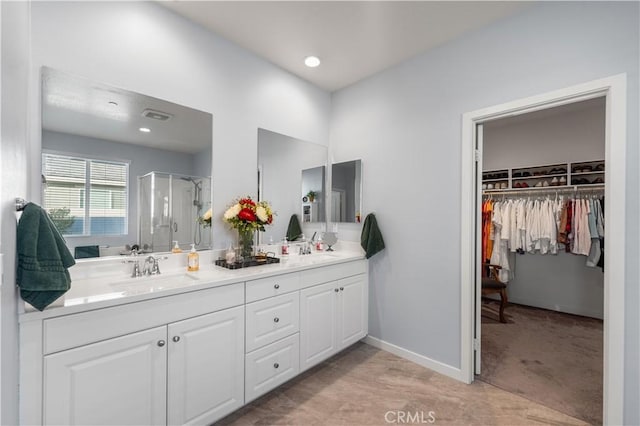 bathroom featuring vanity and an enclosed shower