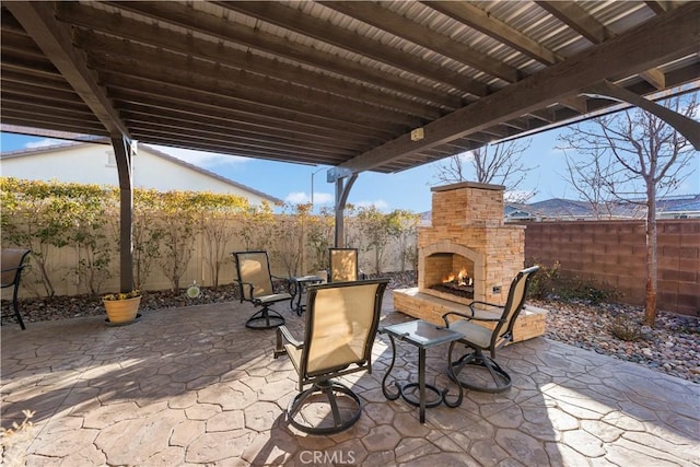 view of patio / terrace featuring an outdoor stone fireplace