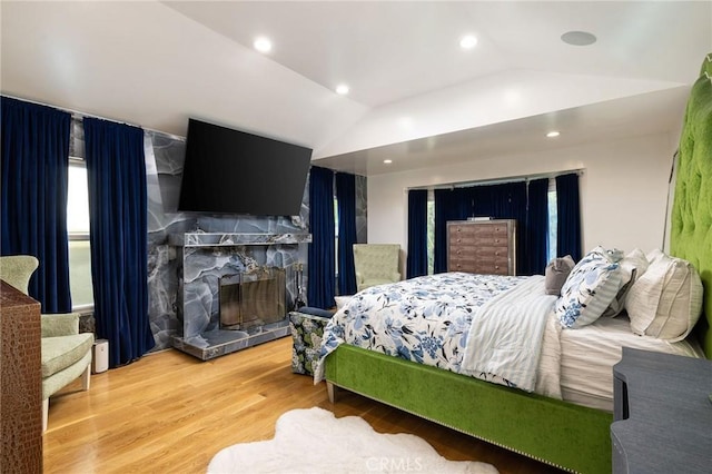 bedroom featuring hardwood / wood-style flooring and lofted ceiling